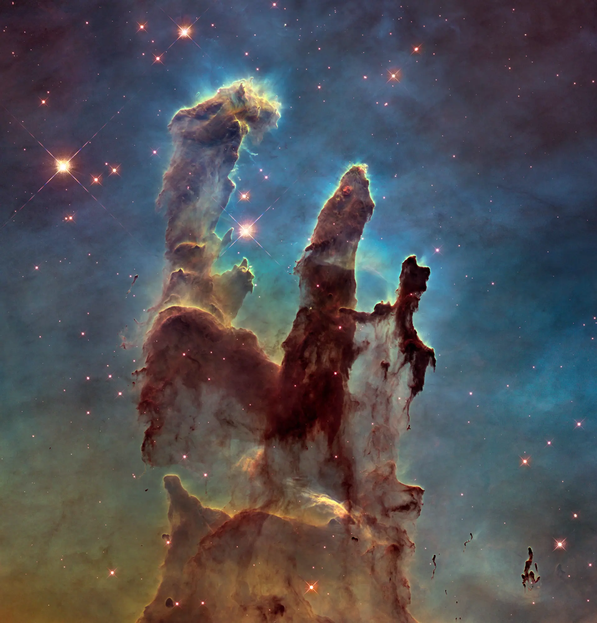 New view of the Pillars of Creation (visible). Credit: NASA, ESA/Hubble and the Hubble Heritage Team. CC BY 4.0. Hubble's visible-light portrait of the Pillars of Creation in the Eagle Nebula