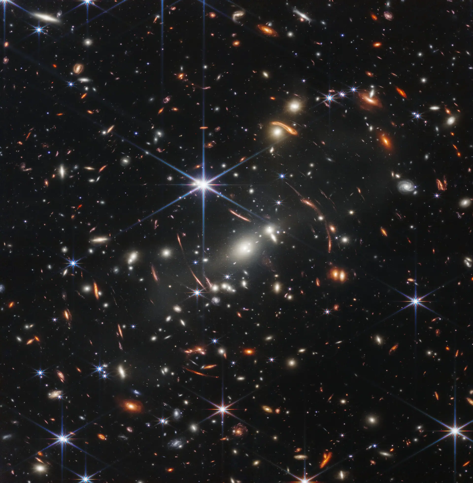 Webb's First Deep Field (NIRCam). Credit: NASA, ESA, CSA, and STScI. CC BY 4.0. Thousands of galaxies in Webb's first deep field, bent into arcs by a foreground galaxy cluster